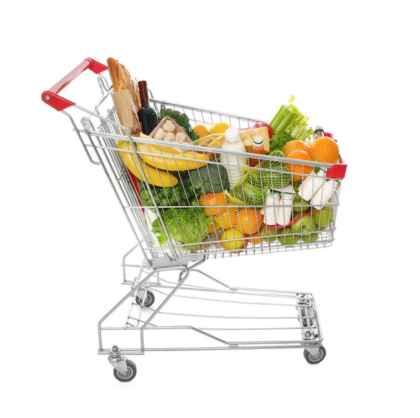 Shopping cart full of groceries on white background - Fotoğraf, Görsel