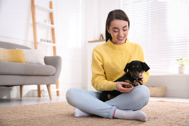 Woman with cute puppy indoors. Lovely pet - Photo, Image