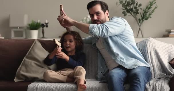 Happy bonding different male generations playing with wooden pistols. - Materiał filmowy, wideo