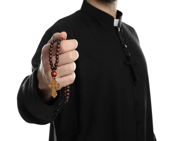 Priest with rosary beads on white background, closeup - Photo, Image