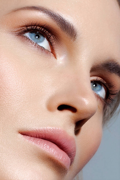 Close-up of a beautiful woman's face. Nude makeup, skin care - Fotó, kép