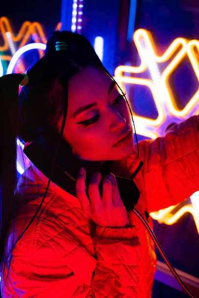 red lighting near young asian woman talking on retro telephone  - Photo, image