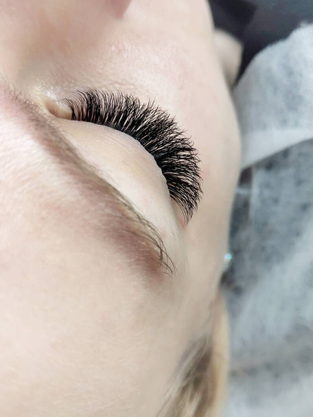 Lash extensions in beauty salon macro eye top view  - Photo, Image