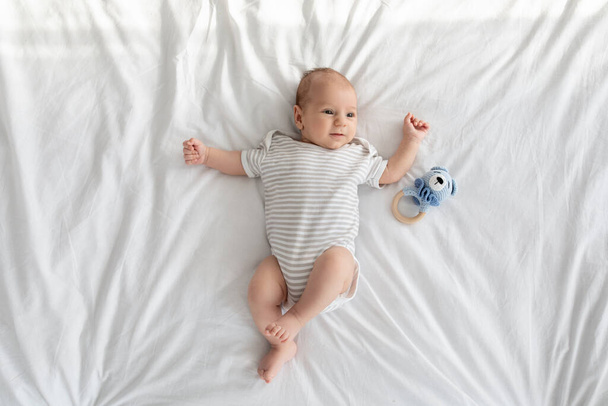 Adorable Small Infant Boy Or Girl Resting On Bed At Home, - Foto, Imagen