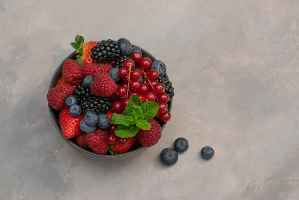 Ripe sweet different berries in bowl. Close up, top view, high resolution product. Harvest Concept - Photo, image