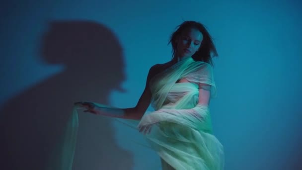 slow motion of young woman in chiffon dress on blue - Footage, Video