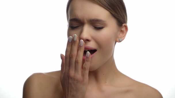 tired woman with bare shoulders yawning on white  - Footage, Video