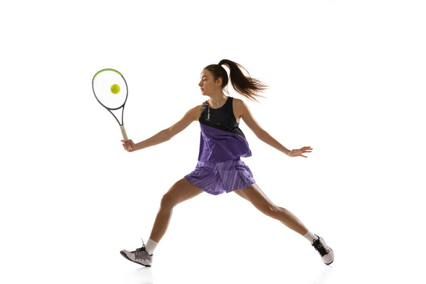 Young caucasian woman playing tennis isolated on white studio background in action and motion, sport concept - Photo, image