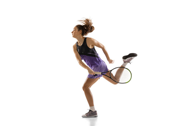 Young caucasian woman playing tennis isolated on white studio background in action and motion, sport concept - Fotó, kép