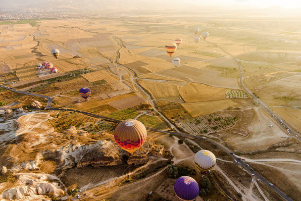 Aerial view of valley with hot air balloons flying in Cappadocia, Turkey.  - 写真・画像