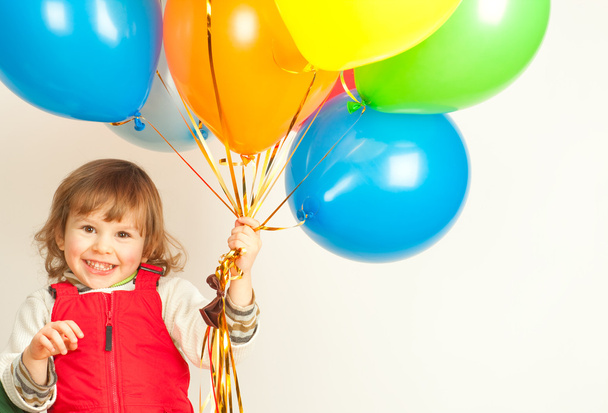 Little girl in red with balloons - Фото, изображение