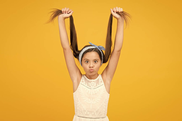 Hair straightening. Adorable little girl perfect long hair. Shampoo and conditioner. Hairdresser salon. Hair styling technique flattening and straightening. Smooth streamlined and sleek appearance - 写真・画像