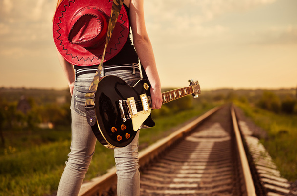 Woman with guitar at railway - Foto, Imagen