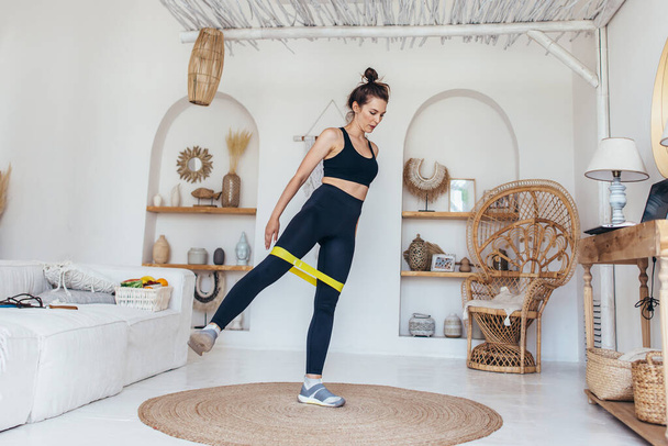 Woman working out at home with elastic band - Zdjęcie, obraz
