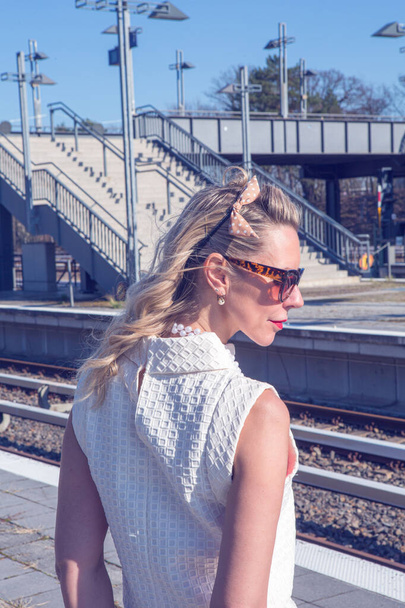 beautiful blonde woman in her 40s at train station - Zdjęcie, obraz