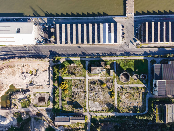 Aerial view of a quarry with an abandoned oil refinery plant along Tagus river in Lisbon, Portugal. - Photo, Image
