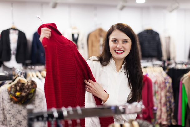 Ordinary woman choosing sweater - 写真・画像