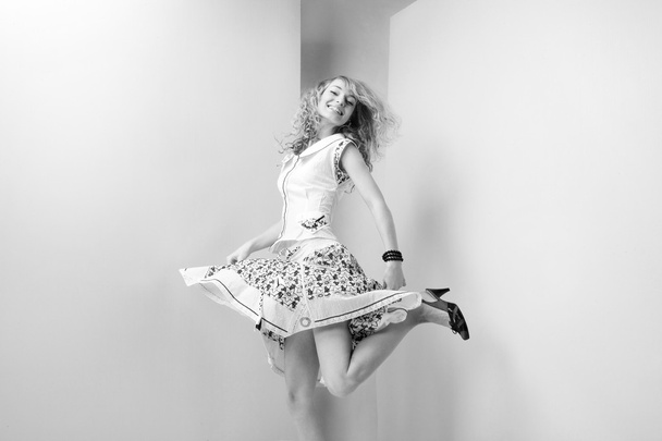 Young Woman jumps and fun in the studio - Фото, зображення