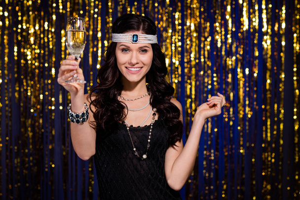 Photo of gorgeous positive lady arm raise champagne glass have good mood isolated on shiny decorated curtain - Fotó, kép