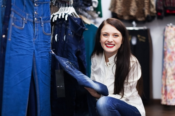 Smiling Woman choosing jeans - Photo, Image