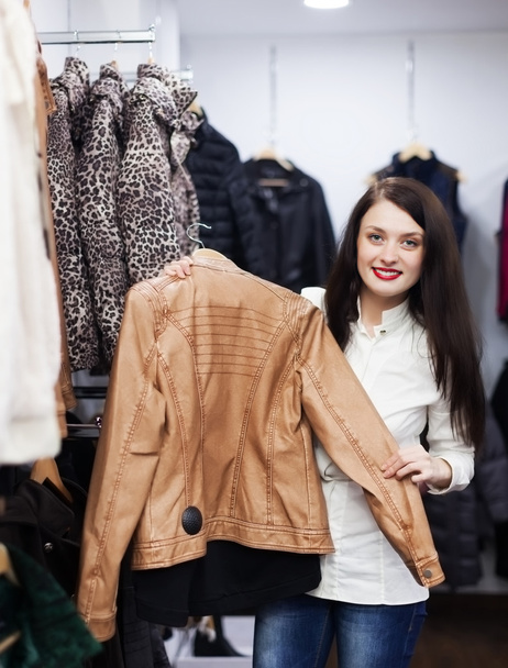 girl choosing jacket at clothing store  - Zdjęcie, obraz