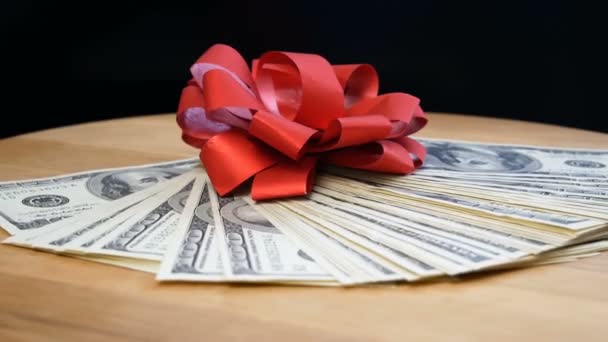 stack of usa dollars and bow on fireworks background, money gift concept - Footage, Video