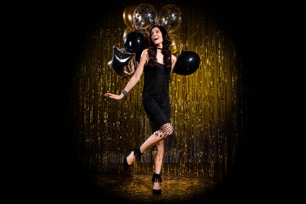 Photo of sweet pretty young lady wear glamour dress dancing holding balloons isolated glitter backdrop background - Valokuva, kuva