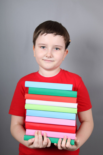 Boy with a pile of books - Foto, immagini