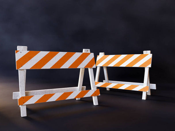 Deux barrières de construction de routes à rayures orange et blanches sur fond sombre - Photo, image
