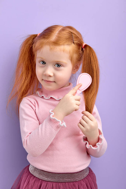 Caucasian Redhead Child Girl Combing Hair Posing At Camera - Photo, image