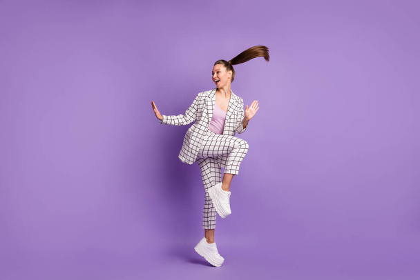 Full size photo of young funky funny smiling positive girl with flying hair dancing isolated on violet color background - Fotoğraf, Görsel