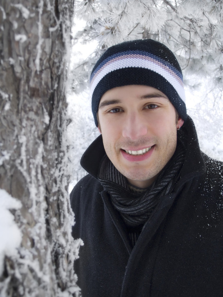 Young man smiling in winter park - Photo, Image