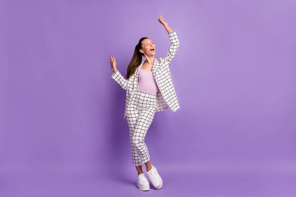 Full length photo of attractive funky young woman raise hands good mood dance isolated on purple color background - Valokuva, kuva