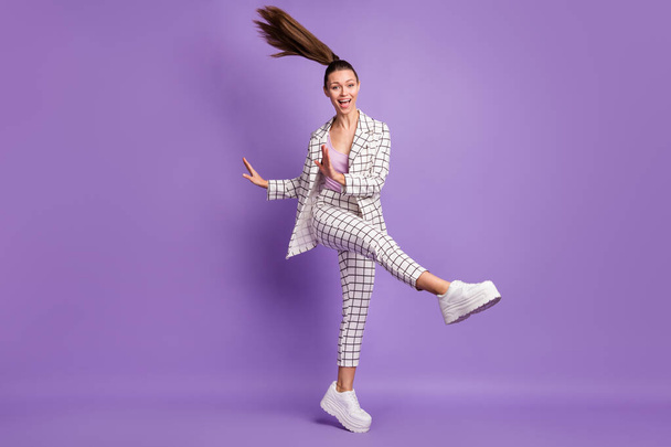 Full size photo of young lovely happy excited crazy positive girl with flying hair dancing isolated on purple color background - Foto, immagini