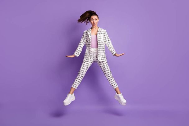 Full size photo of young attractive girl amazed shocked surprised news fake novelty jump up isolated over purple color background - Φωτογραφία, εικόνα