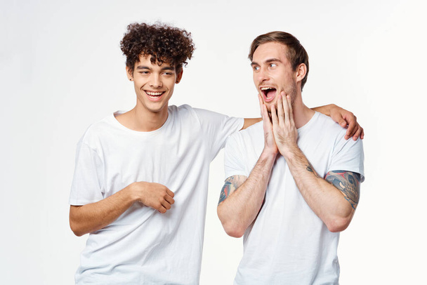 two guys in white t-shirts next to friendship communication emotions - Fotoğraf, Görsel