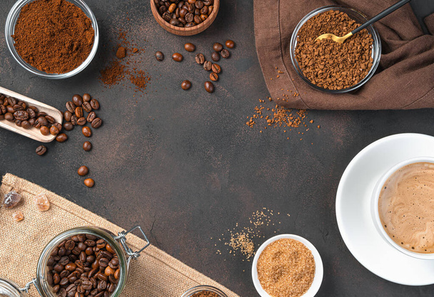 Grain, instant and granulated coffee and a cup of coffee on a brown background. Copy space. - Photo, Image
