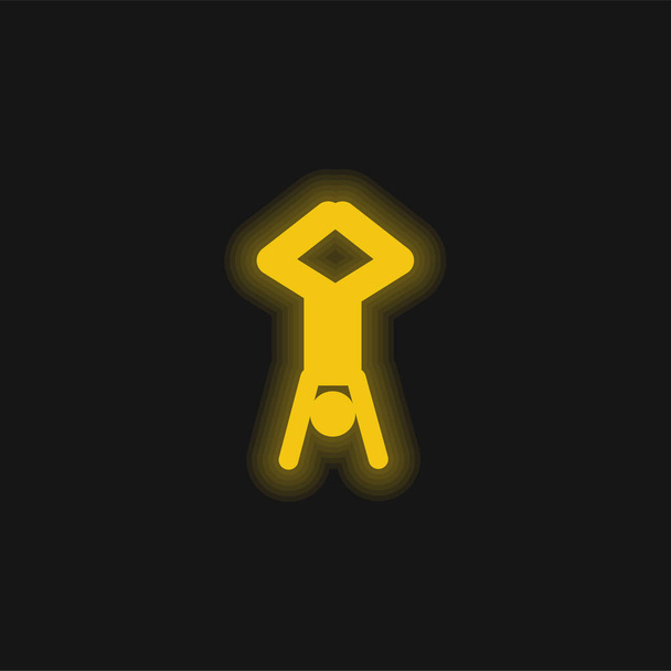 Akrobatenstellung Silhouette mit Kopf nach unten und Beinen nach oben gelb leuchtende Neon-Symbol - Vektor, Bild