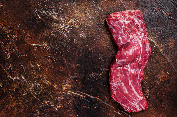 Raw machete skirt beef steak on butcher table. Dark background. Top view. Copy space - Photo, Image