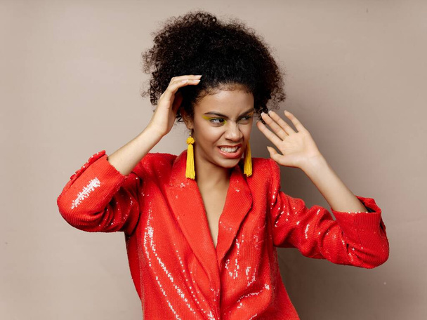 woman with curly hair red jacket jewelry luxury - Фото, зображення