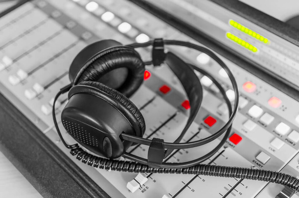 Headphones on sound mixer in radio station studio - Fotoğraf, Görsel