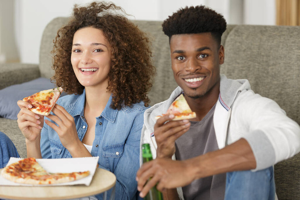 happy couple eating pizza having a great time - Photo, image
