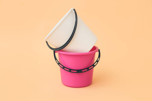 Plastic buckets on color background - Foto, afbeelding