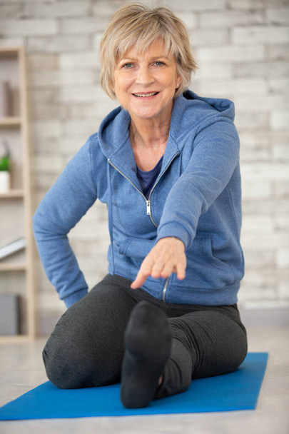 senior woman exercising at home - Фото, изображение