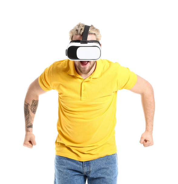 Young man with VR glasses on white background - Photo, image