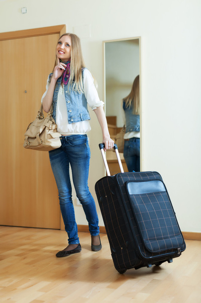 pensive positive woman with suitcase   - 写真・画像