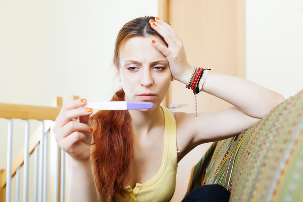 serious girl with pregnancy test   - Fotografie, Obrázek