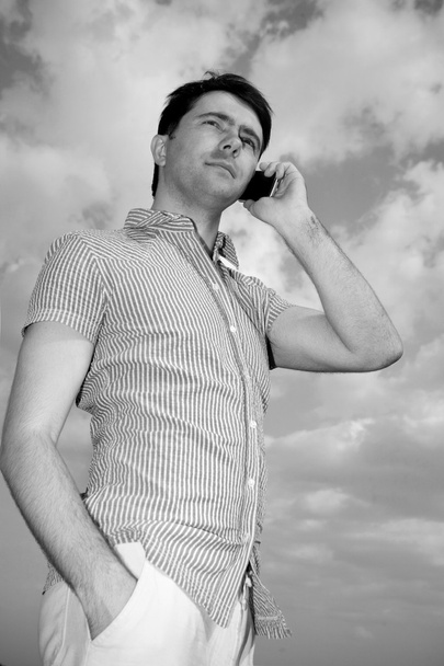 Young man calling on mobile phone, outdoor. Soft focus. Focus on - Fotó, kép