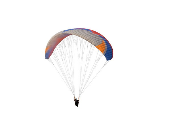 De sportman die op een paraglider vliegt. Prachtige paraglider in vlucht op geïsoleerde witte achtergrond. - Foto, afbeelding