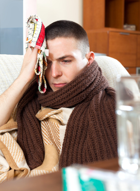 Sad  man having headache holding towel on head - Fotografie, Obrázek